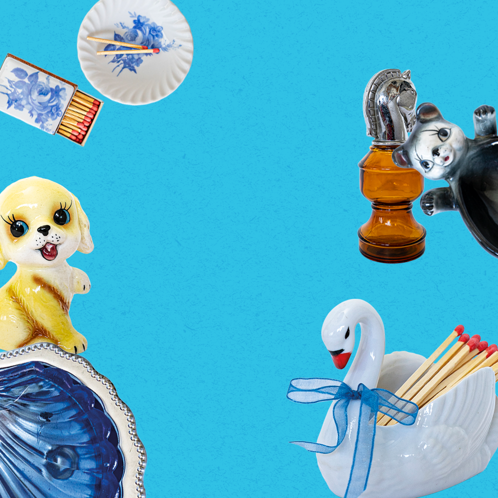 Collection of decorative items including a dog figurine, matchbox holder, and swan-shaped matchbox on a blue background.