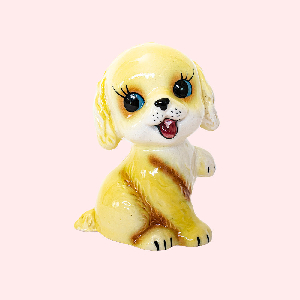 Second-hand, vintage Japan-style ceramic piggy bank from the 50's, representing a golden retriever with big eyes. 