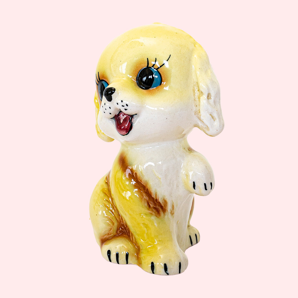 Second-hand, vintage Japan-style ceramic piggy bank from the 50's, representing a golden retriever with big eyes. 