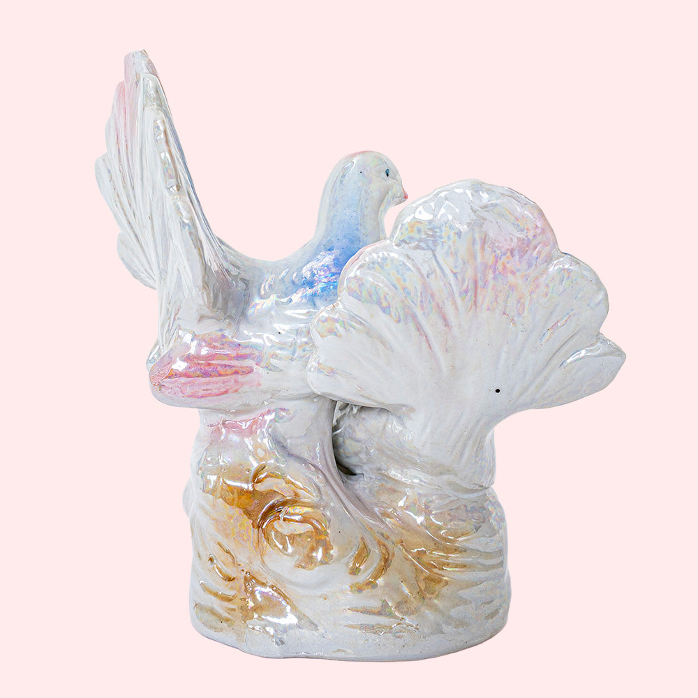 Second-hand, decorative ceramic figurine representing two doves with colorful wings and tails. It has an iridescent glaze. Seen from the back.