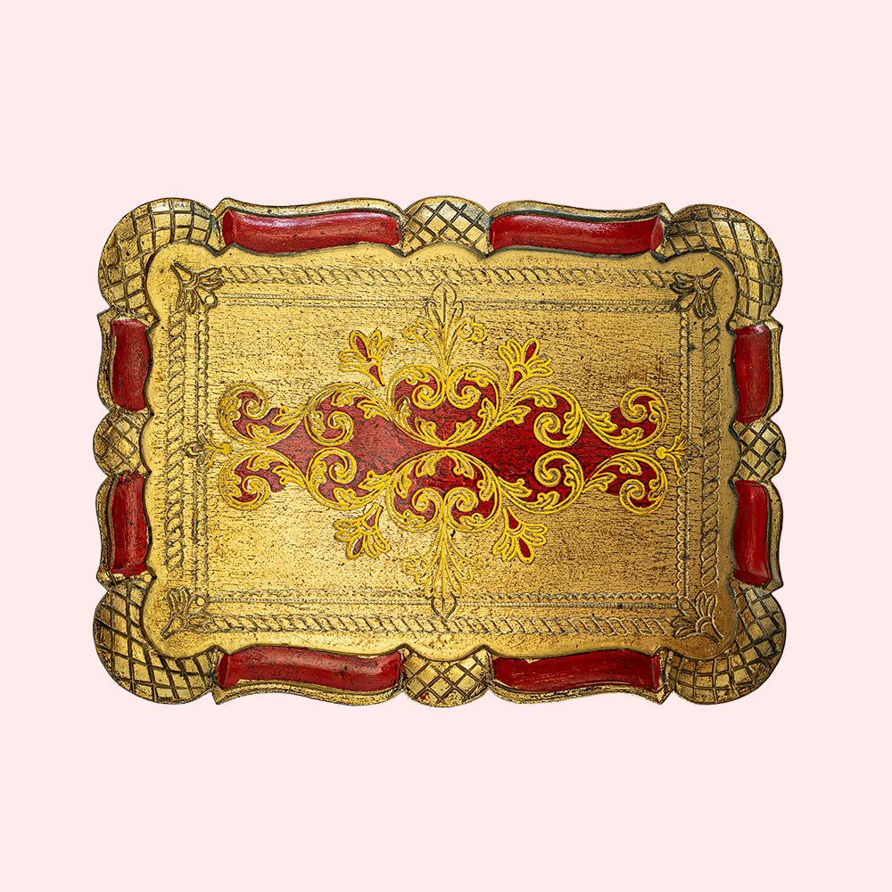 Vintage decorative gold and red rectangular plate with intricate patterns.