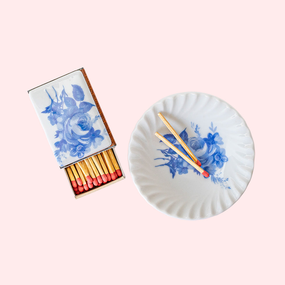 A vintage set of a porcelain plate and matchbox with a porcelain plating, both white with blue flowers. 