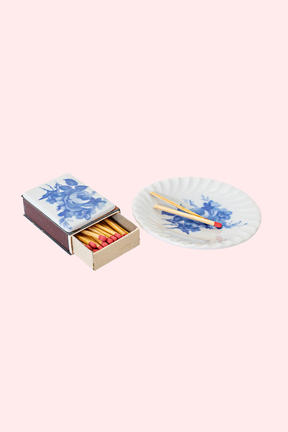 A vintage set of a porcelain plate and matchbox with a porcelain plating, both white with blue flowers. 