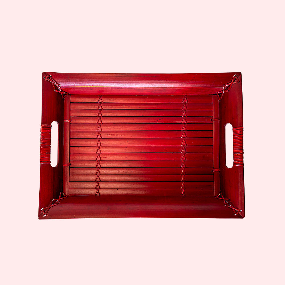 A vintage rectangular bamboo tray painted red. Seen from above.